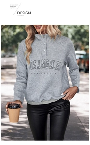 Detail of grey quilted pullover with Los Angeles lettering and buttoned stand collar