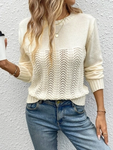 Detail of minimalist cream knit sweater with hollow out wave pattern and crew neck