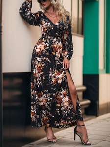 Detail of V-neck wrap floral maxi dress with high side slit in black and orange print