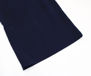 Detailed view of navy blue fabric texture and precision hem stitching on trousers
