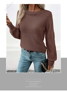Close-up of dark brown knit sweater with textured stripe patterns and round neckline