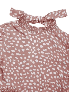 Detail of ruffle high neck and bow tie back on a leopard print long sleeve dress