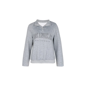 Detail showing grey quilted fabric texture and Los Angeles lettering on sweatshirt
