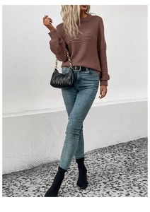 Detail view of brown knit sweater featuring unique horizontal pleated texture and crew neck
