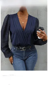 Detail of navy blue V-neck bodysuit with pleated texture and sheer jacquard long sleeves