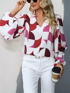 Detail of V-neck ruffle collar and geometric print on a long sleeve chiffon blouse