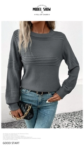 Detail view of dark grey ribbed knit sweater featuring vertical striped textures and crew neck