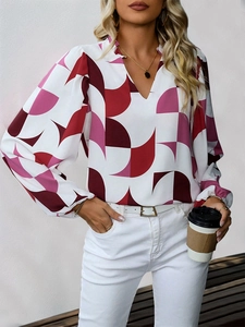 Detail of V-neck long sleeve blouse with geometric print and stylish lantern sleeves