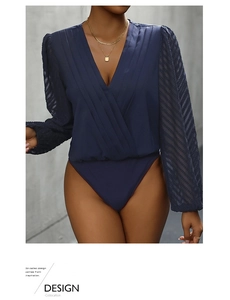 Detailed close-up of V-neck bodysuit featuring pleated chest and sheer mesh pattern sleeves