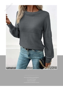 Detail of dark grey crew neck sweater showing horizontal knit texture and ribbed cuffs