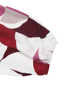 Close-up of geometric pattern sleeve with elastic cuffs on a modern printed blouse
