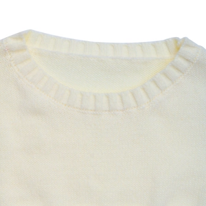 Close-up of the ribbed crew neck design on a minimalist cream white knit sweater