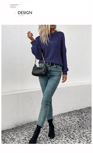 Detail shot of purple long sleeve knit sweater with textured ribbing and crew neck finish