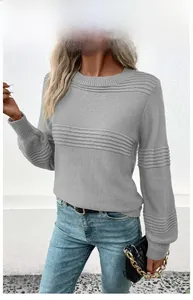 Detail of grey knitted sweater showing horizontal ribbed texture and soft lantern sleeves