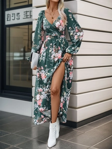 Detail of V-neck wrap dress in dark green with floral print and high leg slit