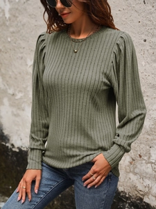 Detailed texture of green ribbed knit sweater with elegant puff sleeve design details