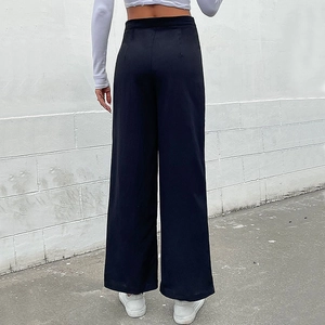 Women's black high-waisted wide-leg trousers shown from a stylish back view street angle