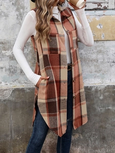 Detail of vintage long plaid vest with orange brown pattern and practical side pockets