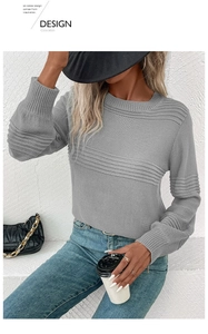 Detail of grey long sleeve knit sweater showing unique ribbed texture on the chest and sleeves