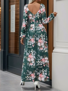 Back view of a long-sleeved V-neck floral dress in dark green with pink flowers