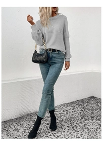 Close-up of light grey crewneck knit sweater with horizontal pleated stripe details