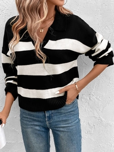 Detail of loose-fit black and white striped knit sweater with polo collar and V-neckline