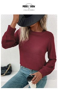 Detail shot of burgundy crew neck knit sweater with horizontal ribbing on sleeves
