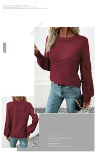 Detail view of burgundy knit sweater with ribbed cuffs and horizontal textured stripes