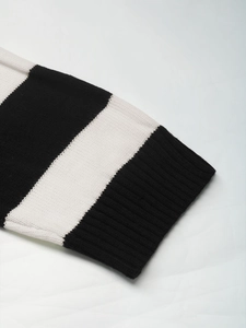 Close-up of knit texture and ribbed cuff on a black and white striped sweater