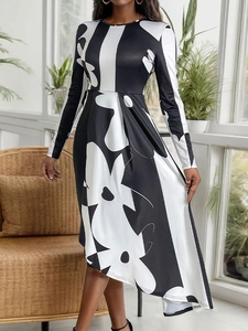 Women's long sleeve crewneck dress featuring black and white floral print and irregular hem