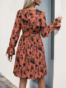 Detail of pleated floral maxi dress showing the back view and waist tie closure