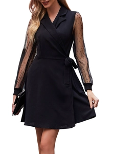Detail of sheer mesh sleeves with polka dot pattern on black lapel wrap dress