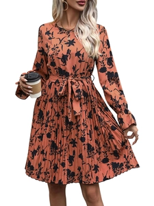 Detailed view of the pleated skirt hem and floral print on a long sleeve dress
