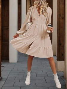 Detail of V-neck long sleeve tiered midi dress with button-front and cinched waistline