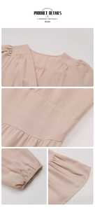 Detail view of the V-neckline and elastic waist stitching on a pink long sleeve dress
