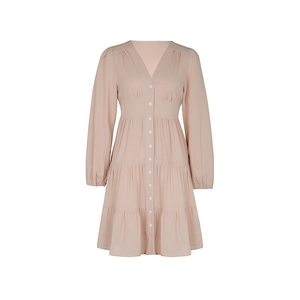 Detail view of pink V-neck long sleeve dress with tiered skirt and button front design