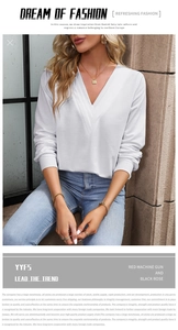 Close-up detail of white V-neck long sleeve top with layered design and ribbed cuffs