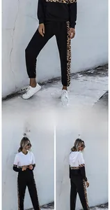 Detail view of women's two-piece tracksuit with leopard print panels on hoodie and joggers