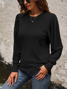 Detail of black ribbed knit long sleeve top with puff sleeves and round neckline
