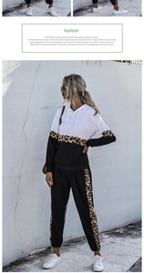 Detail view of women's two-piece tracksuit with leopard print patches and color block design