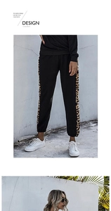 Detail of black jogger pants featuring leopard print side stripes and ribbed cuffs
