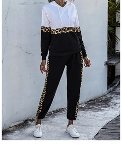 Detailed close-up of hooded tracksuit with leopard print stripes on sleeves and pants