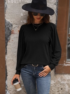 Close-up of black ribbed knit long sleeve shirt with vintage puff shoulder detail