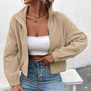 Women's light brown corduroy jacket with waffle texture, stand collar, and short cut design