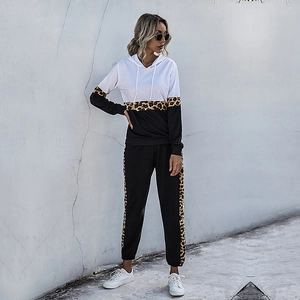 Women's two-piece tracksuit featuring hooded leopard print sweatshirt and black joggers