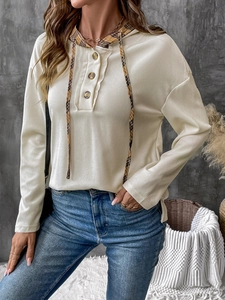 Close-up of waffle knit texture and plaid hood lining on this women's beige hoodie
