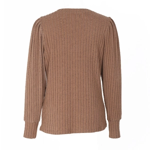 Detail of brown ribbed knit top featuring subtle puffed shoulders and long cuffed sleeves
