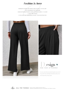 Detailed view of women's black ribbed knit wide-leg pants showing texture and elastic waist