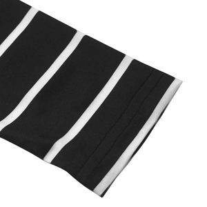 Close-up detail of double-stitched cuffs on a black and white striped long sleeve top