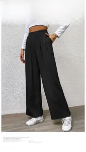 Detailed view of the ribbed texture and elastic high waistband on black wide leg pants